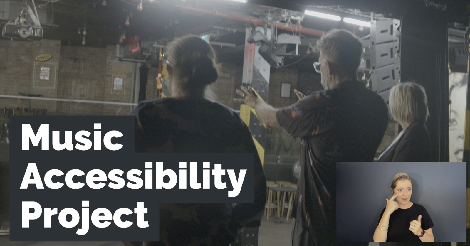 Shot from the stage of Oxford Art Factory, an Auslan interpreter and project title 'Music Accessibility Project."