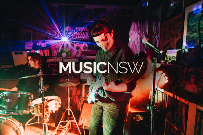 Band performing in Howl & Moan Records in Byron Bay with the MusicNSW logo overlaid