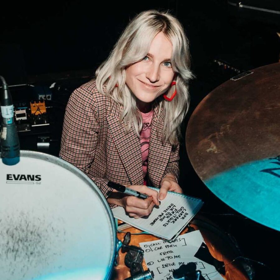 Zoe Catterall Zoe Catterall sitting in front of a drum kit